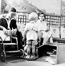 Child being fitted for new shoes in a London shoe shop, c1950s. Artist: Henry Grant
