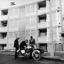 Men with a motorbike, Queen's Crescent, St Pancras, London, 1965.  Artist: Henry Grant