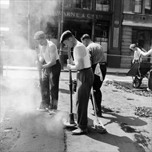 Workers repairing Queen Victoria Street, Westminster, London, 1955. Artist: Henry Grant