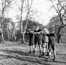 Boys shooting with bows and arrows in Hampstead, London, c1950s. Artist: Henry Grant