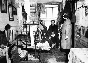 Salvation Army visiting a resident in Notting Hill, London, c1900. Artist: Unknown.