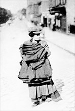 Woman carrying sacks, London, c1900. Artist: Unknown