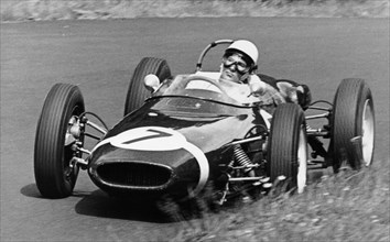 Stirling Moss taking a bend in a racing car, (c1960-c1961?). Artist: Unknown