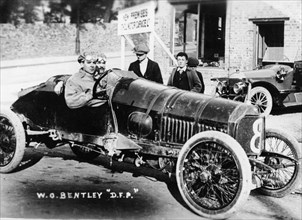 WO Bentley at the wheel of his DFP car, 1914. Artist: Unknown