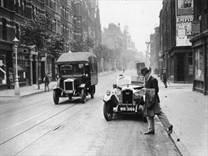A Rover 1928 10/25 HP sports car parked in a London street, 1931. Artist: Unknown