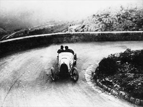 Louis Chiron driving a Bugatti at a hill climb, 1923. Artist: Unknown
