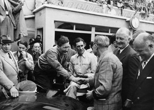Peter Whitehead being congratulated on his victory with Peter Walker of the Le Mans 24 hours, 1951. Artist: Unknown