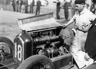 Attilio Marinoni, chief mechanic of Scuderia Ferrari, with an Alfa Romeo, 1934. Artist: Unknown
