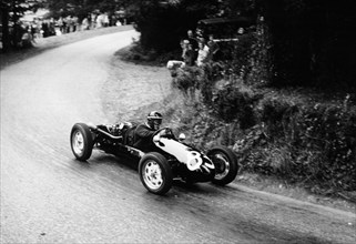 A racing driver speeding round a bend, Harleyford Hill Climb, Buckinghamshire, (c1950-c1960?). Artist: Unknown