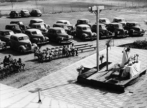 Outdoor church service with cars parked behind, USA, (1950s?). Artist: Unknown