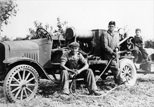Farmworkers with a tractor, (c1930s?). Artist: Unknown