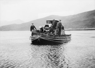 An early ferry transporting a car across a lake. Artist: Unknown