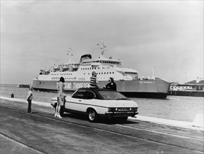 A 1974 Ford Capri on a quay, in front of a Townsend Thoresen car ferry, 1970s. Artist: Unknown