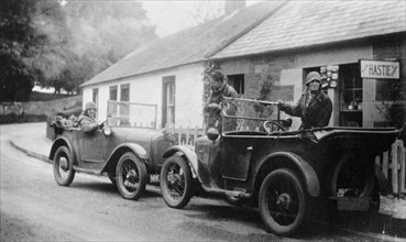 Two Austin Sevens parked outside a small tea shop, c1925. Artist: Unknown