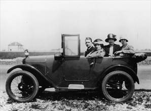 An Austin Seven Chummy with passengers, 1925. Artist: Unknown