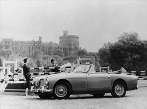 An Aston Martin DB2-4 MKII, with Windsor Castle in the background, 1956. Artist: Unknown