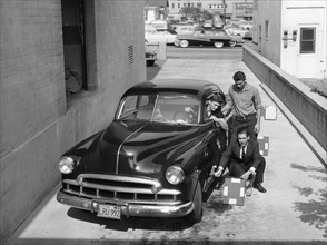 Men with a 1949 customised Chevrolet, (c1949?). Artist: Unknown