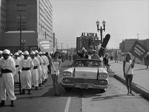 Models and a Cadillac on a parade, USA, (c1959?). Artist: Unknown