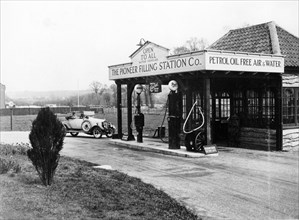 1923 10 hp Calcott arriving at a petrol station, (c1923?). Artist: Unknown