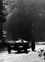 Bernd Rosemeyer driving an Auto Union, Donington Grand Prix, 1937. Artist: Unknown