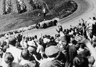 Bernd Rosemeyer acclaimed by the crowd, German Grand Prix, Nurburgring, 1936. Artist: Unknown