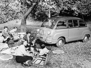 People enjoying a picnic beside a 1956 Fiat 600 Multipla, (c1956?). Artist: Unknown