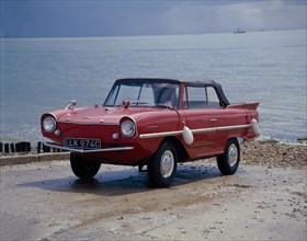 A 1965 Amphicar at the water's edge. Artist: Unknown