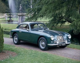 A 1952 Aston Martin DB2 saloon car photographed in a stately garden. Artist: Unknown