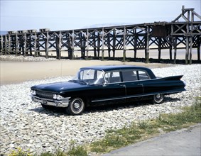 A 1961 Cadillac Presidential limousine on a beach. Artist: Unknown