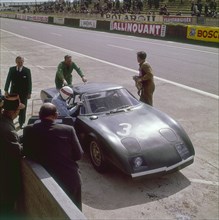 Jackie Stewart getting into a Rover BRM turbine, Le Mans, France, 1965. Artist: Unknown