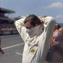 Graham Hill getting ready for the French Grand Prix, Le Mans, France, 1967. Artist: Unknown