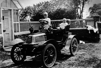 A child at the wheel of a De Dion Bouton car, 1903. Artist: Unknown