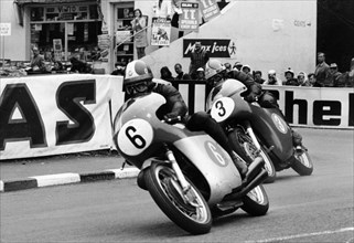 Giacomo Agostini on bike number 6, Tom Dickie on bike number 3, Isle of Man Junior TT, 1968. Artist: Unknown