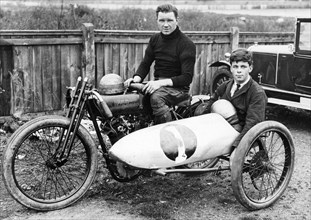 FW Dixon on a Harley-Davidson, with a passenger in the sidecar, 1921. Artist: Unknown