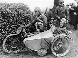 Freddie Dixon and passenger Walter Denny, Isle of Man sidecar TT race, 1923. Artist: Unknown