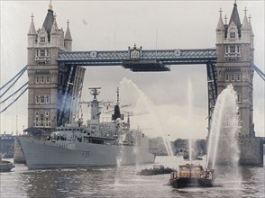 View of HMS London sailing beneath Tower Bridge, London, 1988. Artist: Anon