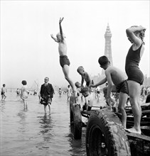 Children in swimming costumes jump into the sea, Blackpool, c1946-c1955