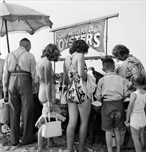 Holidaymakers around a seafood stall, Blackpool Beach, c1946-1955