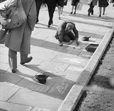 An ex-serviceman working as a pavement artist in central London, c1948-1959