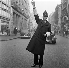 An informal portrait of a traffic policeman standing in the road, City of London, c1946-c1959