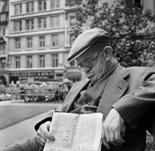 An elderly man asleep with his newspaper, City of London, c1946-c1959