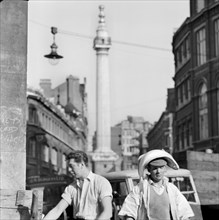An informal portrait of two porters outside Billingsgate Fish Market, London, c1946-c1959