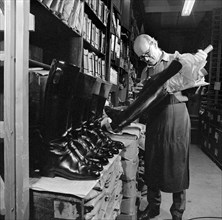 The interior of the workshop where Mr Eric Lobb is at work on a boot, London, c1946-c1959