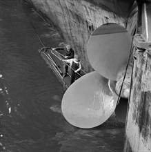Cleaning the propellor of a ship, London Docks, September 1965