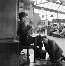 Shoeblack at Waterloo Station, London, 1962-1964