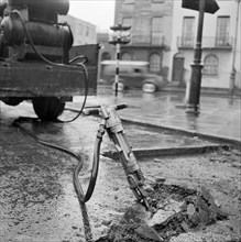 Road works with pneumatic drill, London, 1960-1965
