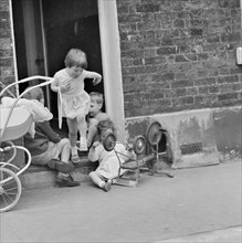 Children playing on a doorstep, London, 1960-1965