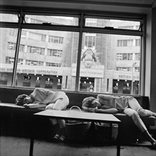 Women asleep in a waiting area, BOAC Air Terminus, London, 1960-1972
