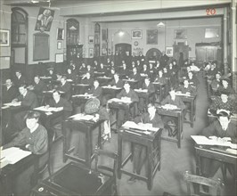 Examination class for male and female students, Queen's Road Evening Institute, London, 1908. Artist: Unknown.