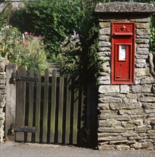 Wall-mounted post box and wooden gate, Upper Slaughter, Cotswolds, Gloucestershire